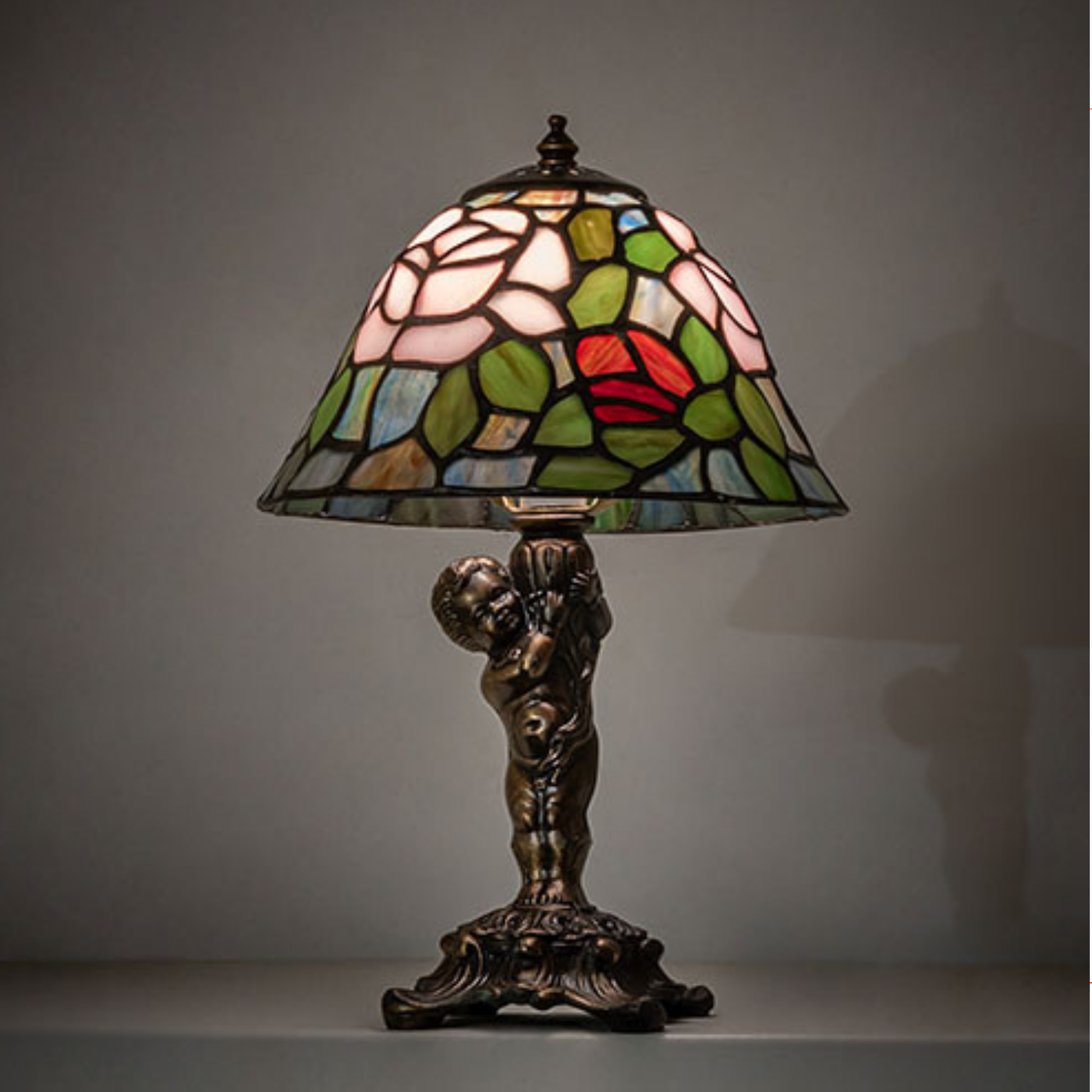 12-inch Tiffany Lamp Rosebush Cherub Accent on dark background