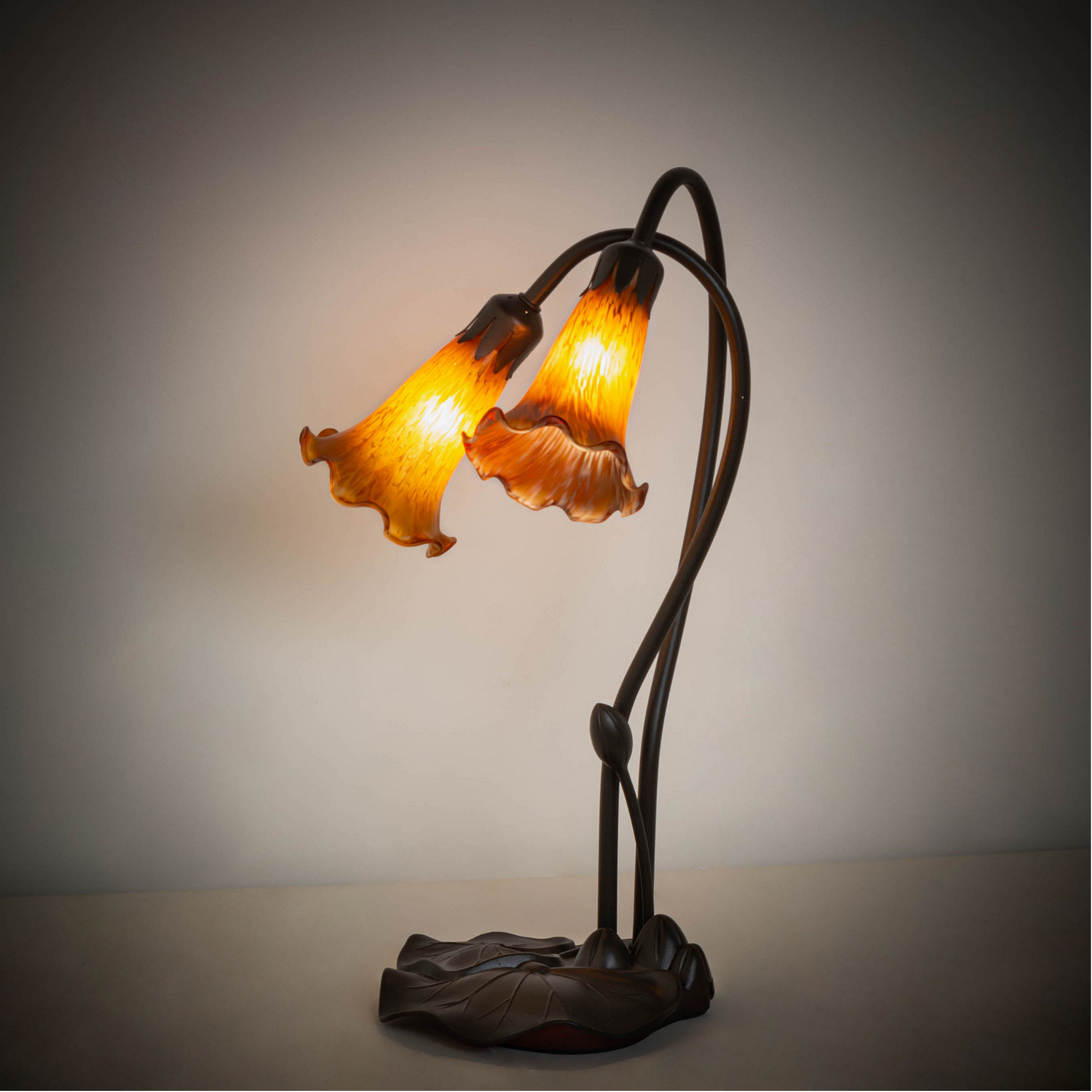 16 inch small tiffany lamp amber pond lily on dark background. 
