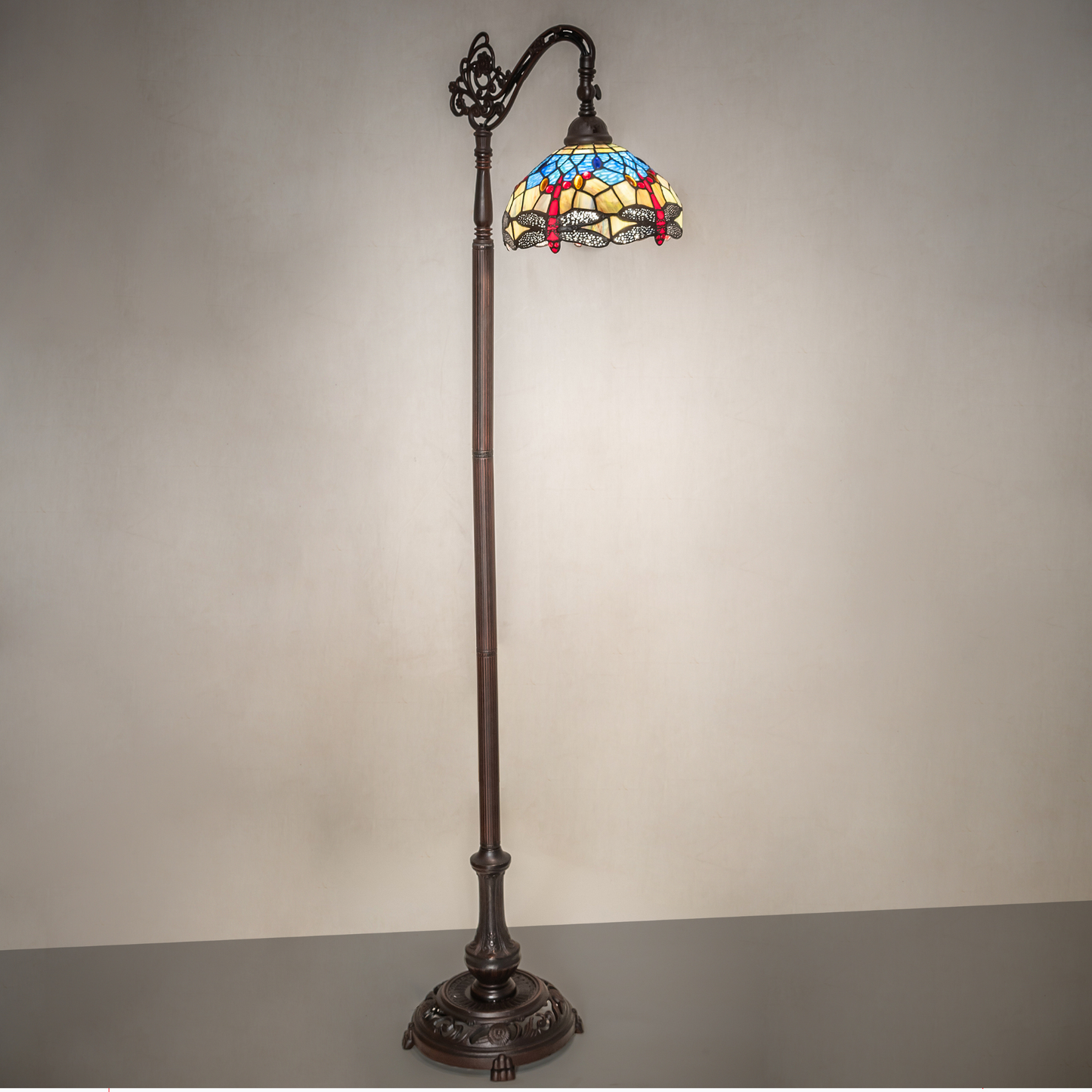 60.5-inch Tiffany floor lamp dragonfly lamp bridge arm on dark background.