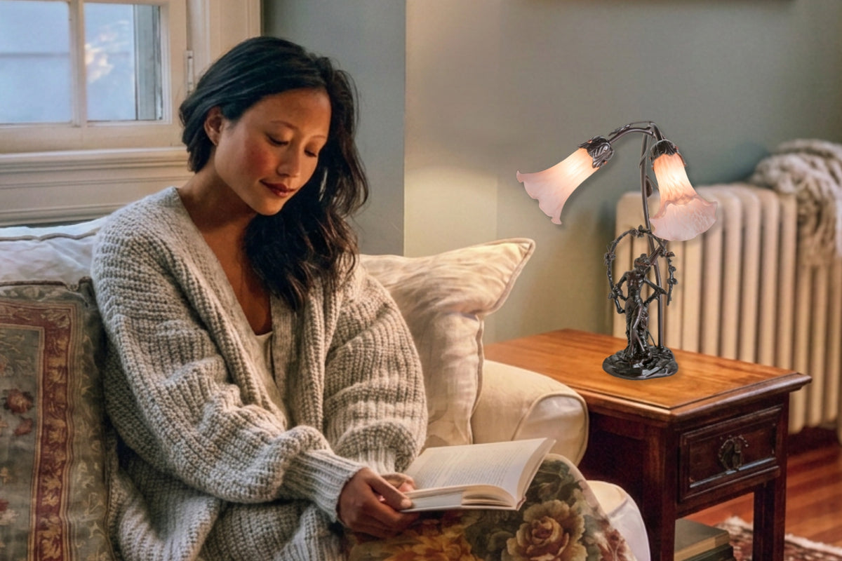Tiffany Pink Pond Lily in living room setting. Woman reading. 